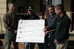Chris Luginbuhl presents checks to Dan Beauregard of Arizona Snowbowl, and Valorie and Al Bowman of Cinder Hills Boarding Kennel